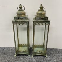 A pair of metal and glass storm lanterns, H. 53cm.