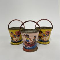 Three early 20th century tin plate children's buckets, H. 15cm.