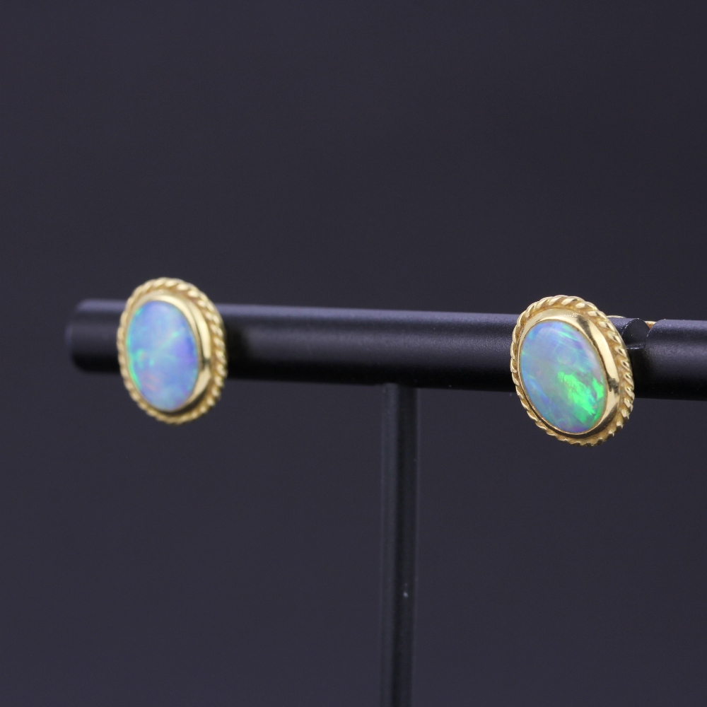 A pair of yellow metal opal set stud earrings, L. 1cm. With 18ct gold backs. - Image 2 of 3