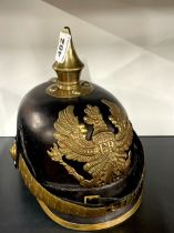 A leather and brass reproduction helmet, front to back 27cm.