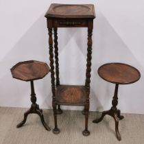 An early 20thC two tier oak plant stand together with two small mahogany tripod side tables, plant