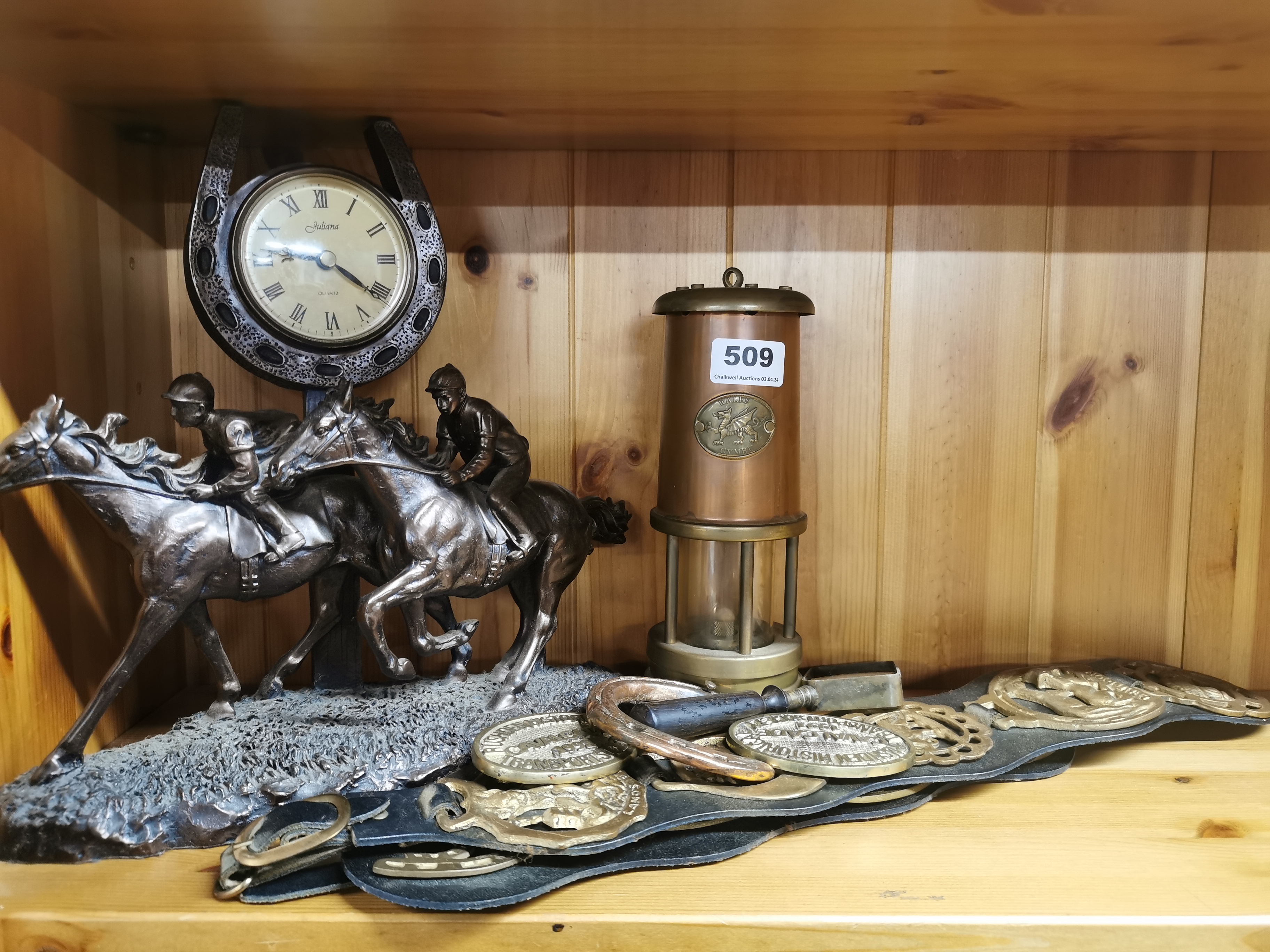 A Welsh miner's lamp, a group of horse brasses and a racehorse clock, clock H. 30cm.