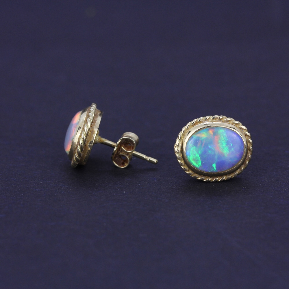 A pair of yellow metal opal set stud earrings, L. 1cm. With 18ct gold backs. - Image 3 of 3