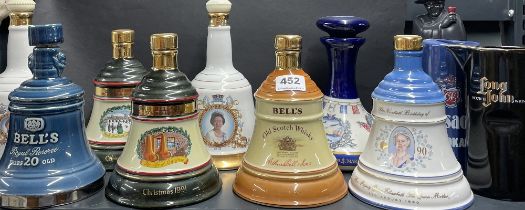 A group of Bell's whiskey ceramic bottles (empty), together with a Sandeman figure bottle (empty)