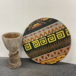 A large old African carved wooden stand and painted wooden circular panel, stand H. 61cm, panel Dia.