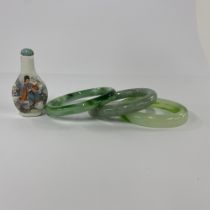 A group of three bangles (1 jade and 2 glass) together with a small snuff bottle