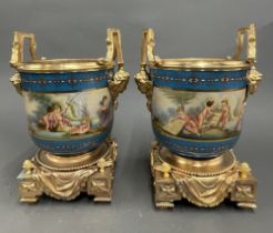 A pair of continental gilt bronze mounted porcelain urns. H. 33cm.