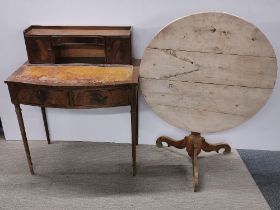 A three drawer mahogany writing desk with leather top together with a light wood circular folding