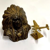 A brass model of an aircraft, together with a painted ceramic figure of a Native American Chief,
