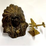 A brass model of an aircraft, together with a painted ceramic figure of a Native American Chief,