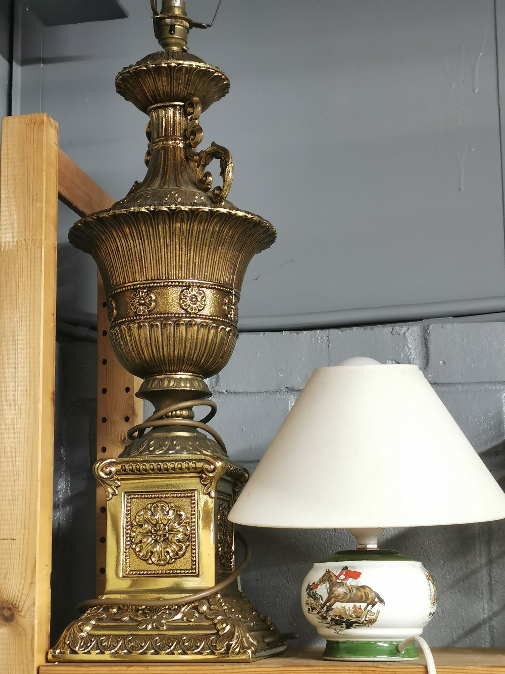 A large gilt brass table lamp, H. 80cm (with frame), together with a smaller table lamp.