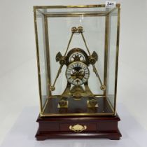 A large contemporary brass grasshopper clock in glass case, H. 55cm, W. 37cm.