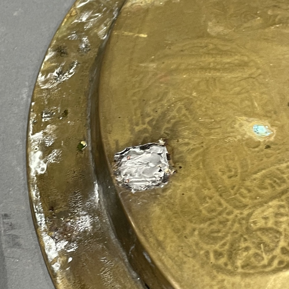 Two 19th / early 20th century Eastern hammered brass trays, one with silver and copper decoration, - Image 5 of 5