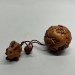 A Chinese carved wooden inro style ball depicting the Zodiac animals, H. 5cm.