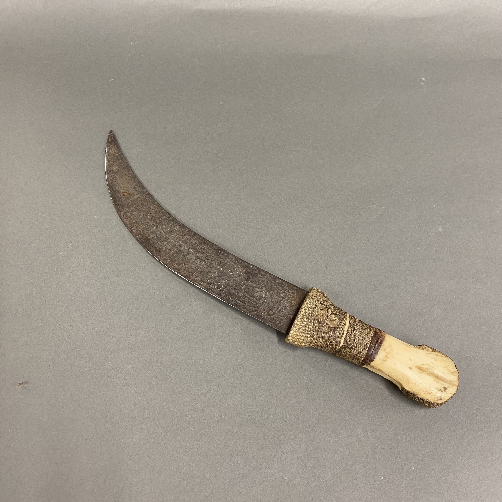 A large Eastern dagger with bone and snakeskin hilt, L. 36cm.