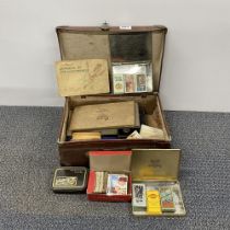 A vintage case of cigarette cards including Wix and sons Henry cards.