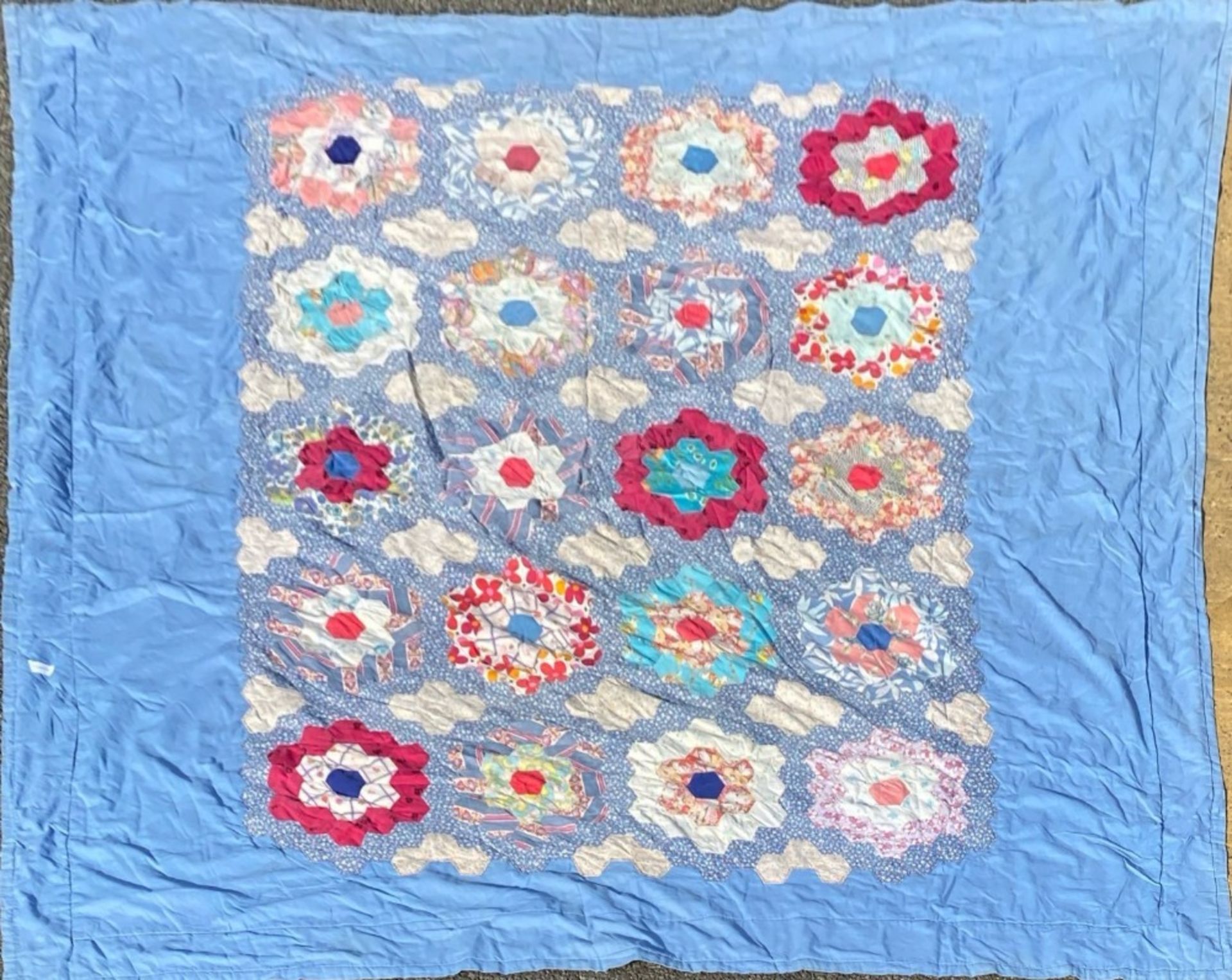 A blue patchwork rug, 225 x 221cm.