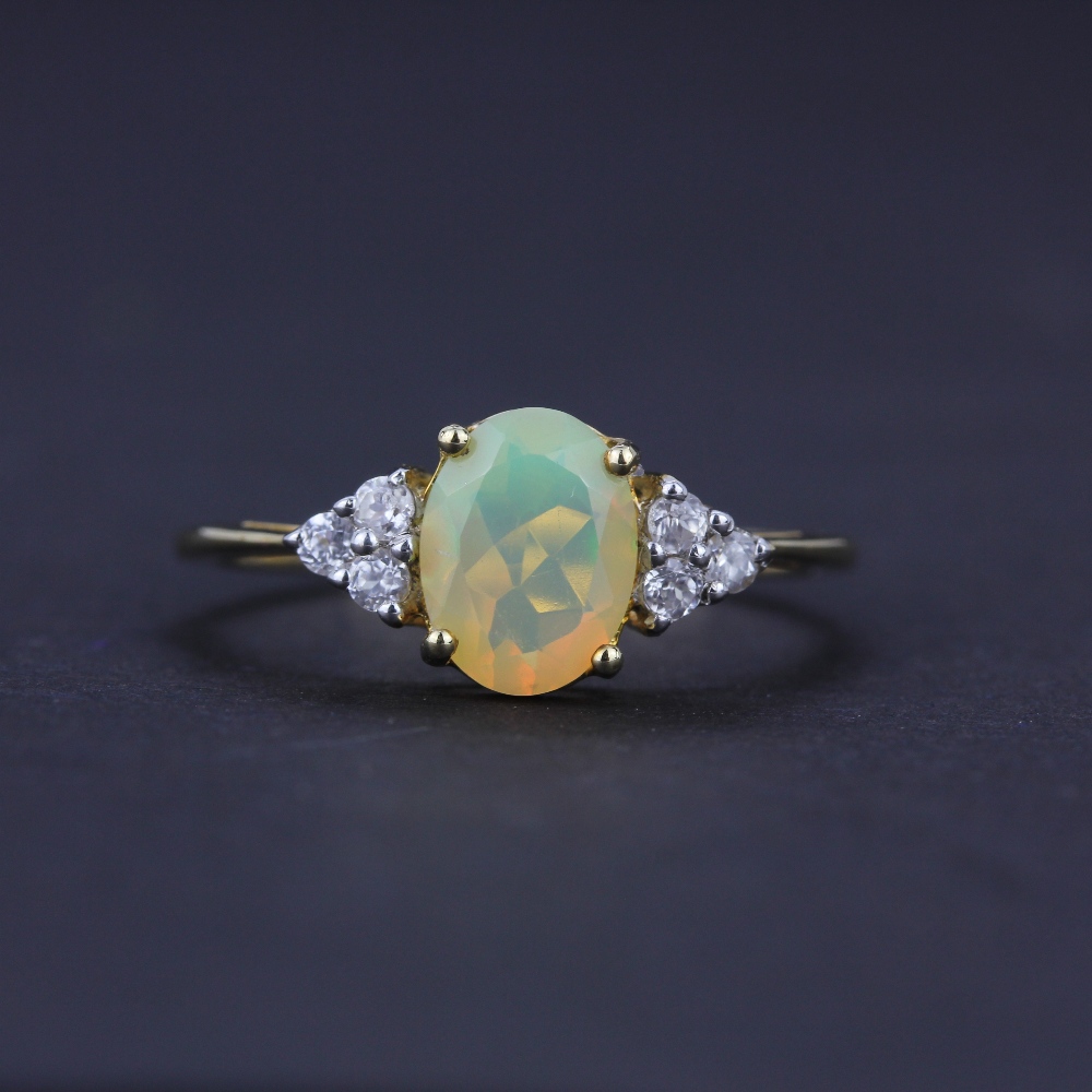 A 10ct yellow gold ring set with an oval cut opal and white topaz, (O), together with a pair of 10ct - Image 2 of 4