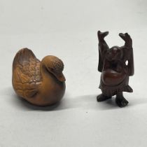 A carved wooden Chinese figure of Putai, together with a carved fruitwood netsuke of a duck, with