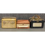 A group of three portable transistor radios including a Roberts R200 and two others.