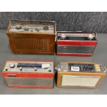 A group of four portable transistor radios including a Bush TR130, Roberts R25 , Roberts RIC2 and