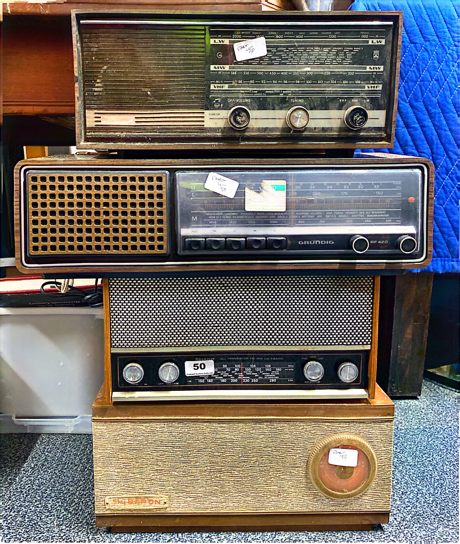 A Sharp transistor radio, model number FY-64E together with a Sky baron radio, Grundig RF420 and
