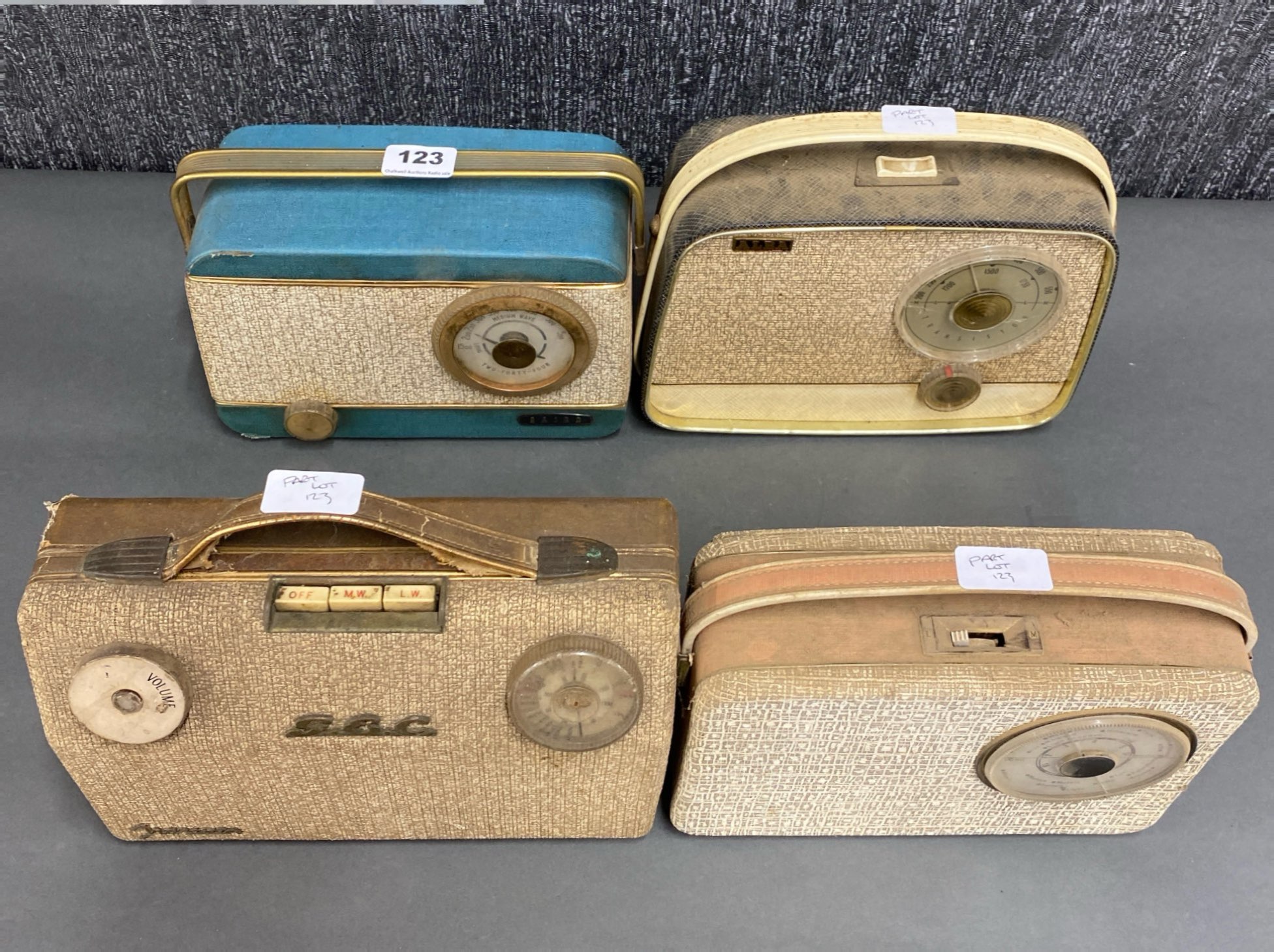 A group of four portable transistor radios including a Baird Two-Fourty-Four, a GEC, an Alba and