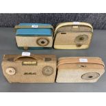 A group of four portable transistor radios including a Baird Two-Fourty-Four, a GEC, an Alba and