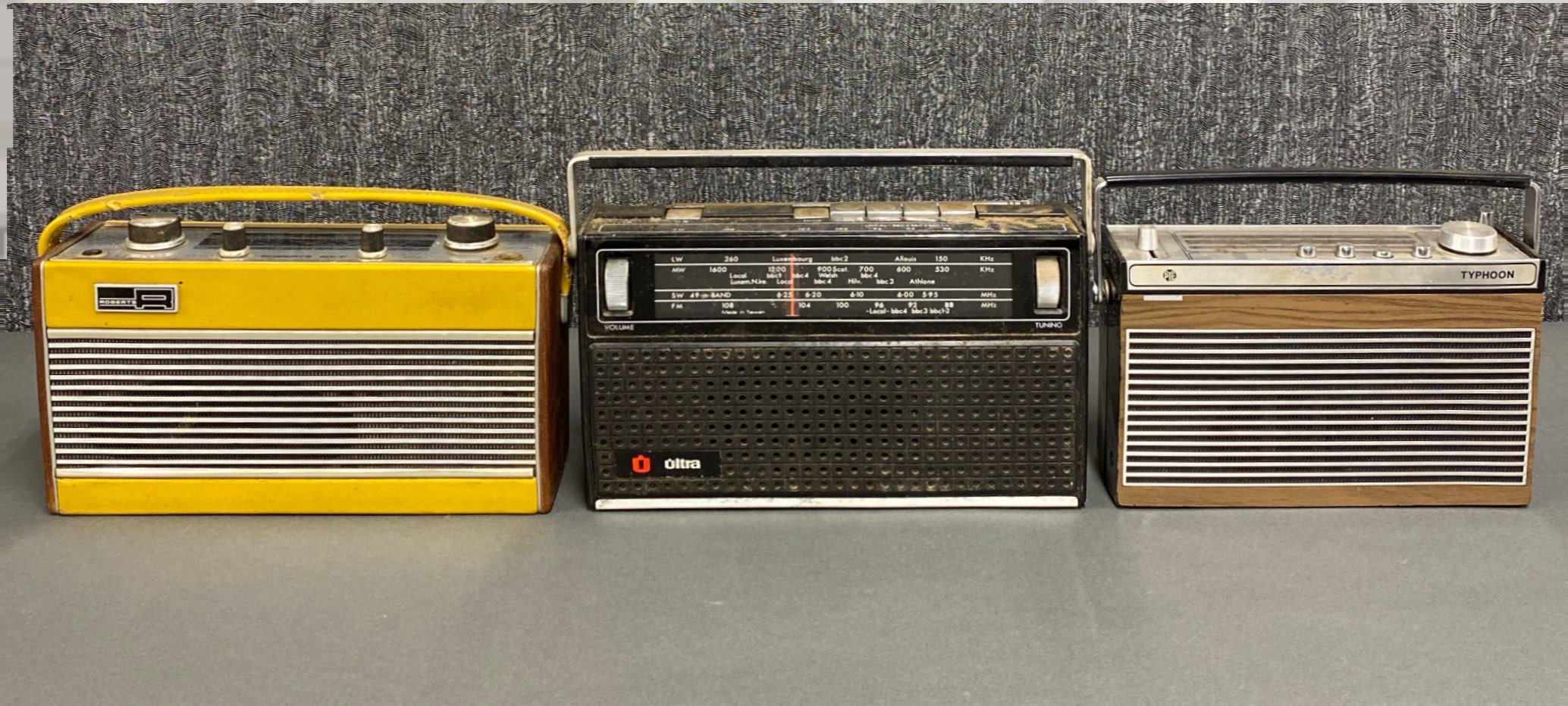 A group of three early solid state transistor radios, including a Pye Typhoon, a Roberts RIC2 and