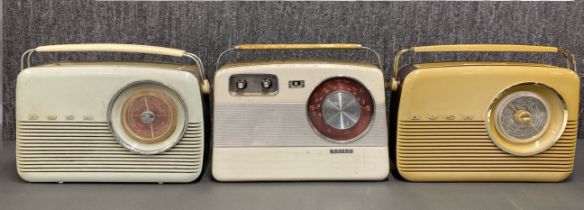 A group of three early transistor radios, two Bush and one Baird.