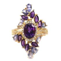 A gold on 925 silver ring set with amethysts and tanzanites, L. 3cm, ring size O.