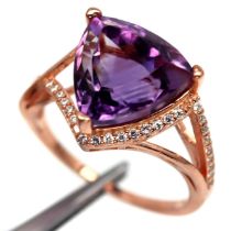 A rose gold on 925 silver ring set with a trillion cut amethyst and white stones, ring size N.5.