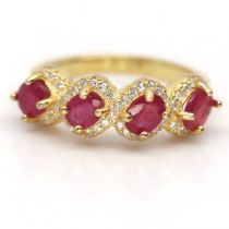 A gold on 925 silver ring set with oval cut rubies and white stones, ring size N.