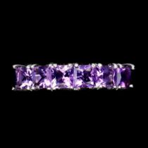 A 925 silver half eternity ring set with princess cut amethysts, ring size O.