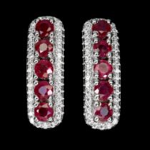 A pair of 925 silver earrings set with round cut rubies and white stones, L. 1.9cm.