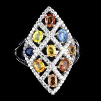 A 925 silver ring set with sapphires and fancy colour sapphires, ring size O.5.