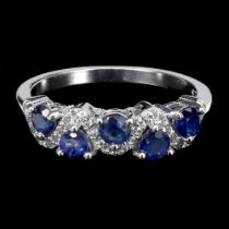 A 925 silver ring set with oval cut sapphires and white stones, ring size N.