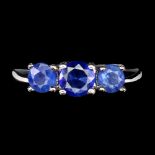 A 925 silver ring set with three round cut sapphires, ring size N.