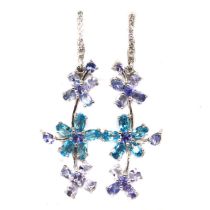 A pair of 925 silver flower shaped drop earrings set with oval cut blue topaz and tanzanites, L. 5cm