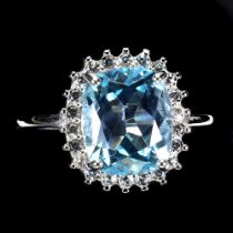 A 925 silver cluster ring set with a cushion cut blue topaz and white stones, ring size P.