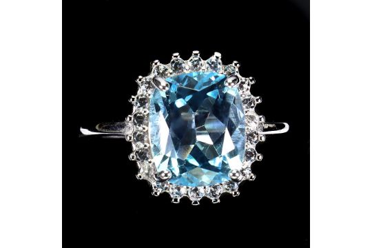 A 925 silver cluster ring set with a cushion cut blue topaz and white stones, ring size P. - Image 1 of 3