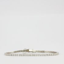 An 18ct white gold tennis bracelet set with brilliant cut diamonds, approx. 3.50ct total, colour F-