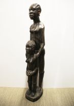 A large African carved figured ebony of a mother and daughter, H. 91cm.