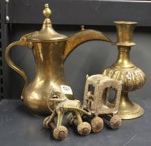 An Indian brass child's toy with an Eastern brass coffee pot and a heavy Indian brass candlestick,