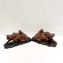 A pair of mid 20thC Chinese carved hardwood figures of water buffalo on carved wooden stands W.