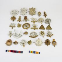 A collection of mixed military cap badges.