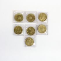 A group of collectible £2 coins.