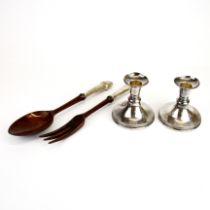 A pair of sterling silver handled wooden salad servers with a pair of sterling silver candle