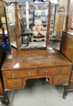 An early 20thC burr walnut veneered four drawer mirror backed dressing table with protective plate