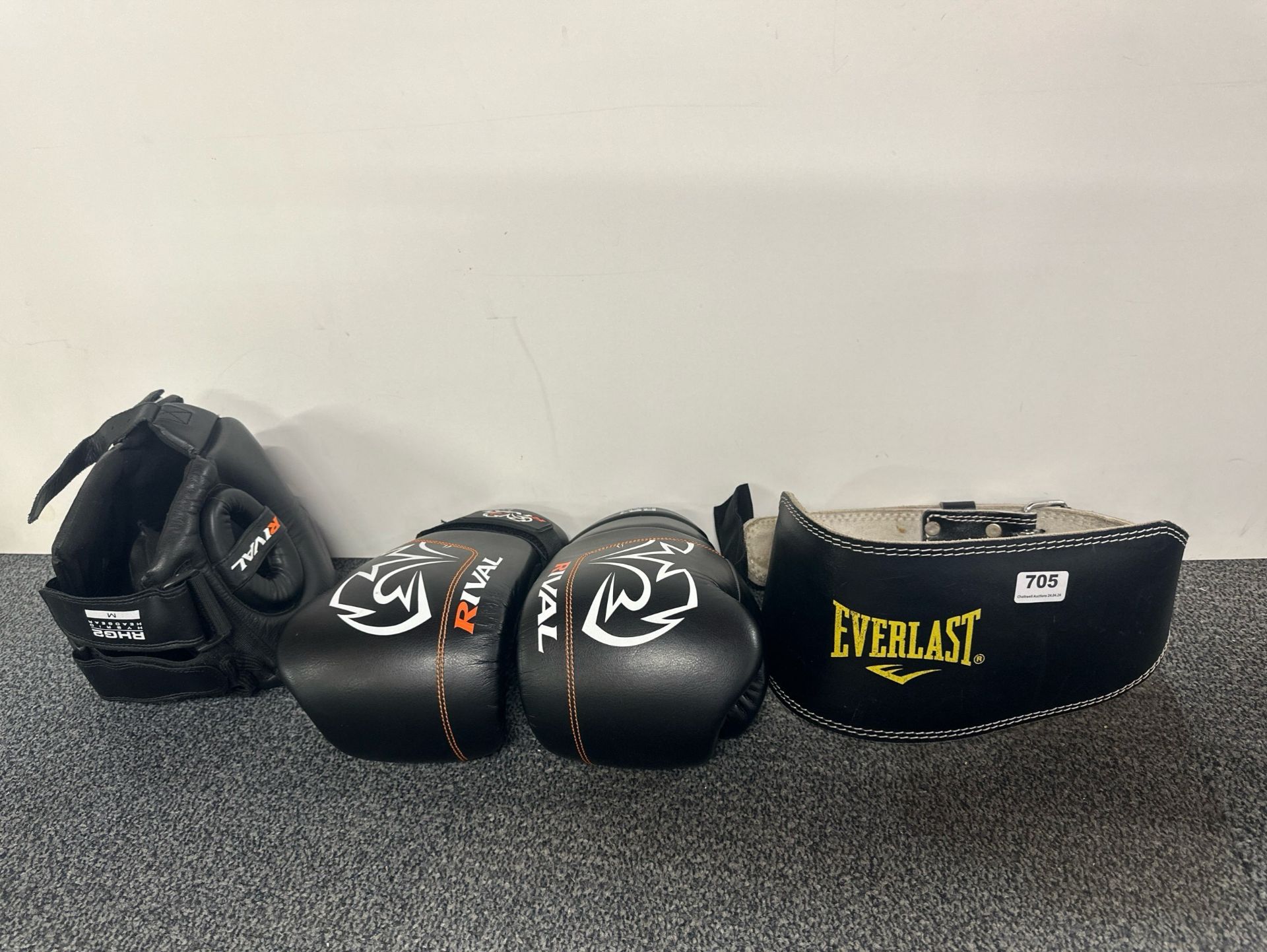 A pair of boxing gloves, helmet and belt.